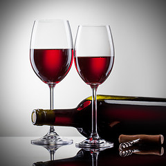Image showing Wine in glasses and bottle on white