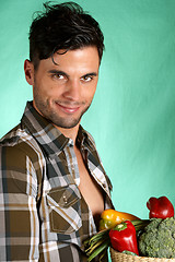 Image showing Handsome farmer holding vegetables