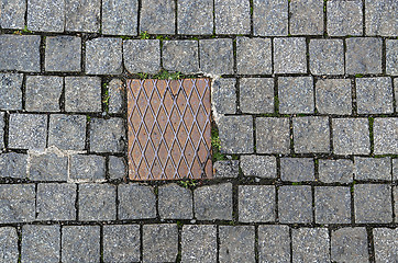 Image showing Paving stones background with metal plate