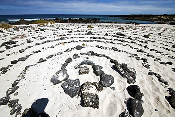 Image showing spiral of black rocks in the white  beach   lanzarote 