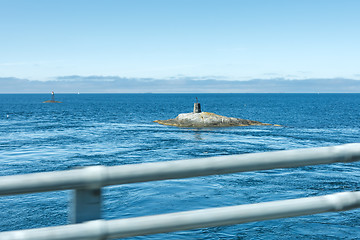 Image showing Lighthouse on the rock looking like submarine.