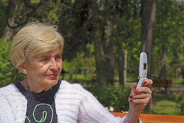 Image showing Senior woman with camera phone