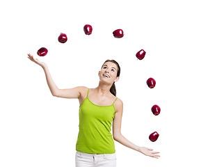 Image showing Woman throwing apples