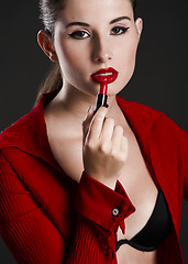 Image showing Applying lipstick