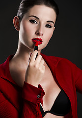 Image showing Applying lipstick