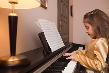 Image showing Little girl playing the piano