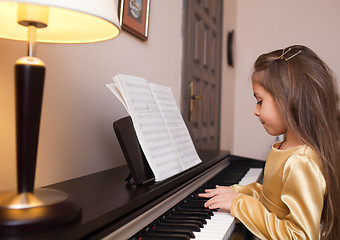 Image showing Little girl playing the piano