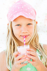 Image showing Young girl drinking smoothie