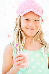 Image showing Smiling young girl holding smoothie drink