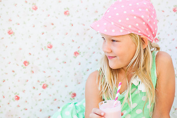 Image showing Smiling young girl holding smoothie drink