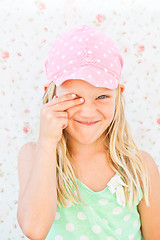 Image showing Cute happy girl covering eye