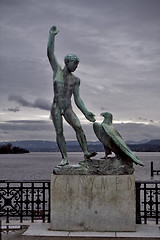 Image showing  man and a eagle near the lake