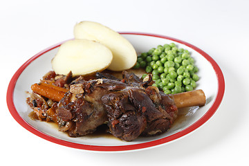 Image showing Braised lamb shanks with potatoes and peas