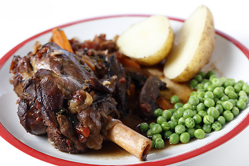 Image showing Lamb shank meal with peas and potato