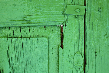 Image showing  piece of colorated green wood as a window