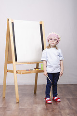 Image showing Girl artist paints on canvas