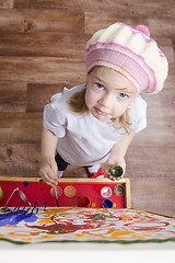 Image showing Girl artist paints on canvas