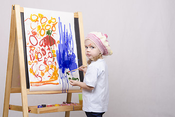 Image showing Girl artist paints on canvas