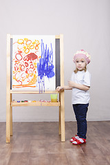 Image showing Girl artist paints on canvas