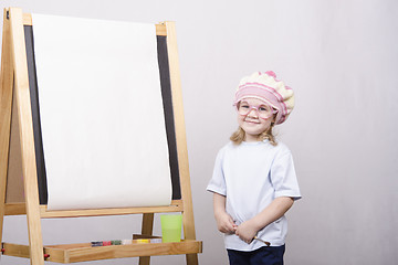 Image showing Girl artist paints on canvas