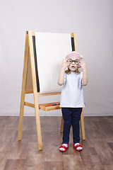 Image showing Girl artist paints on canvas