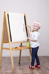 Image showing Girl artist paints on canvas