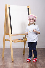 Image showing Girl artist paints on canvas