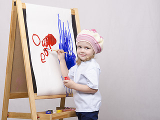 Image showing Girl artist paints on canvas