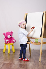 Image showing Girl, the artist draws on easel bear