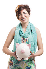 Image showing Happy woman with a piggy bank