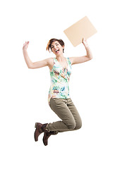 Image showing Beautiful woman jumping and holding a cardboard