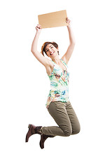 Image showing Beautiful woman jumping and holding a cardboard