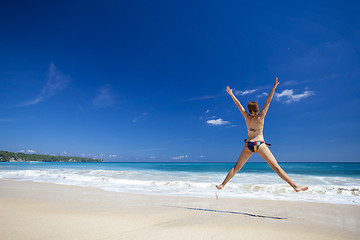 Image showing Woman jumping on the beach