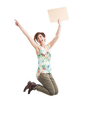 Image showing Beautiful woman jumping and holding a cardboard