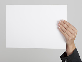 Image showing Holding a paper card