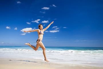 Image showing Woman jumping on the beach