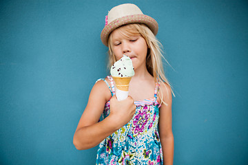 Image showing Young girl holding ice cream