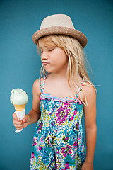 Image showing Young girl holding ice cream cone