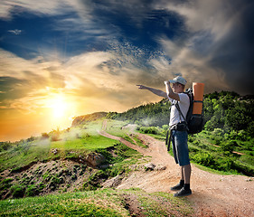 Image showing Tourist on the road in mountains