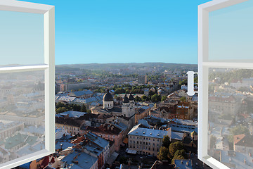 Image showing opened window to the roofs of city