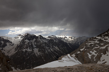 Image showing Snowy mountains and storm clouds