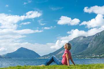 Image showing Woman relaxing enjoying at the fjord coast