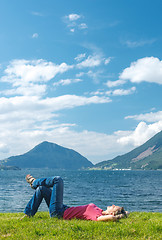 Image showing Woman relaxing enjoying at the fjord coast