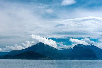 Image showing Fjord scene with hazy mountains and  cloudy sky