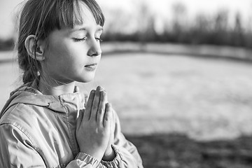 Image showing Young girl praying