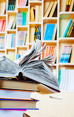 Image showing Open book on a stack of books