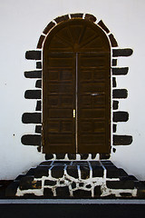 Image showing knocker in a brown closed wood  door 