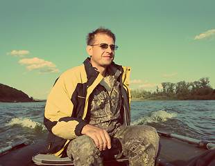 Image showing fishing men on boat with motor - vintage retro style