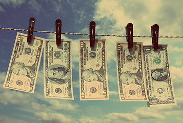 Image showing paper dollars are drying on rope - vintage retro style