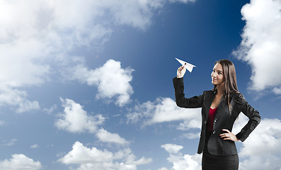 Image showing Business woman throwing a paper plane